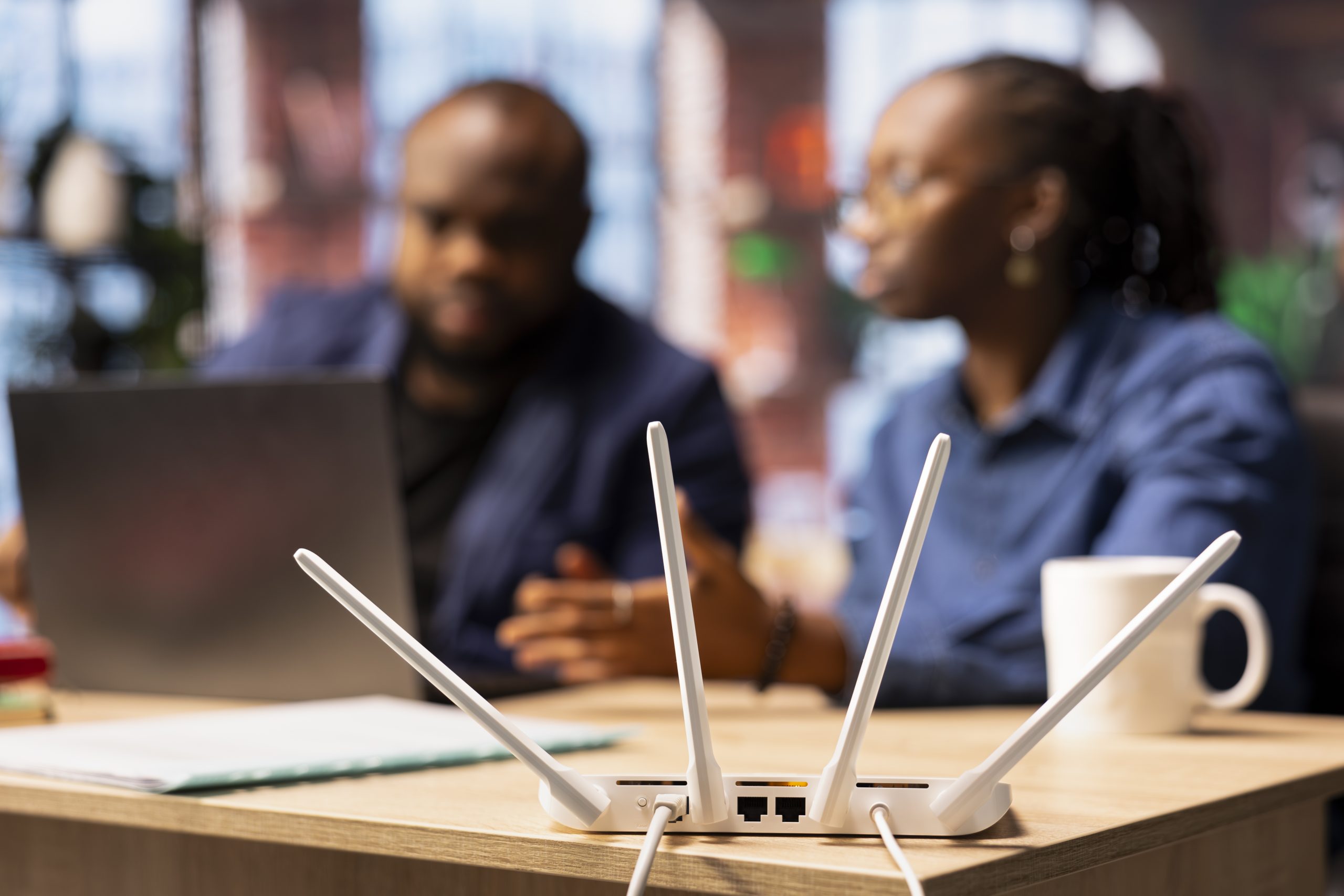 african american couple at home office troubleshooting their wi fi router